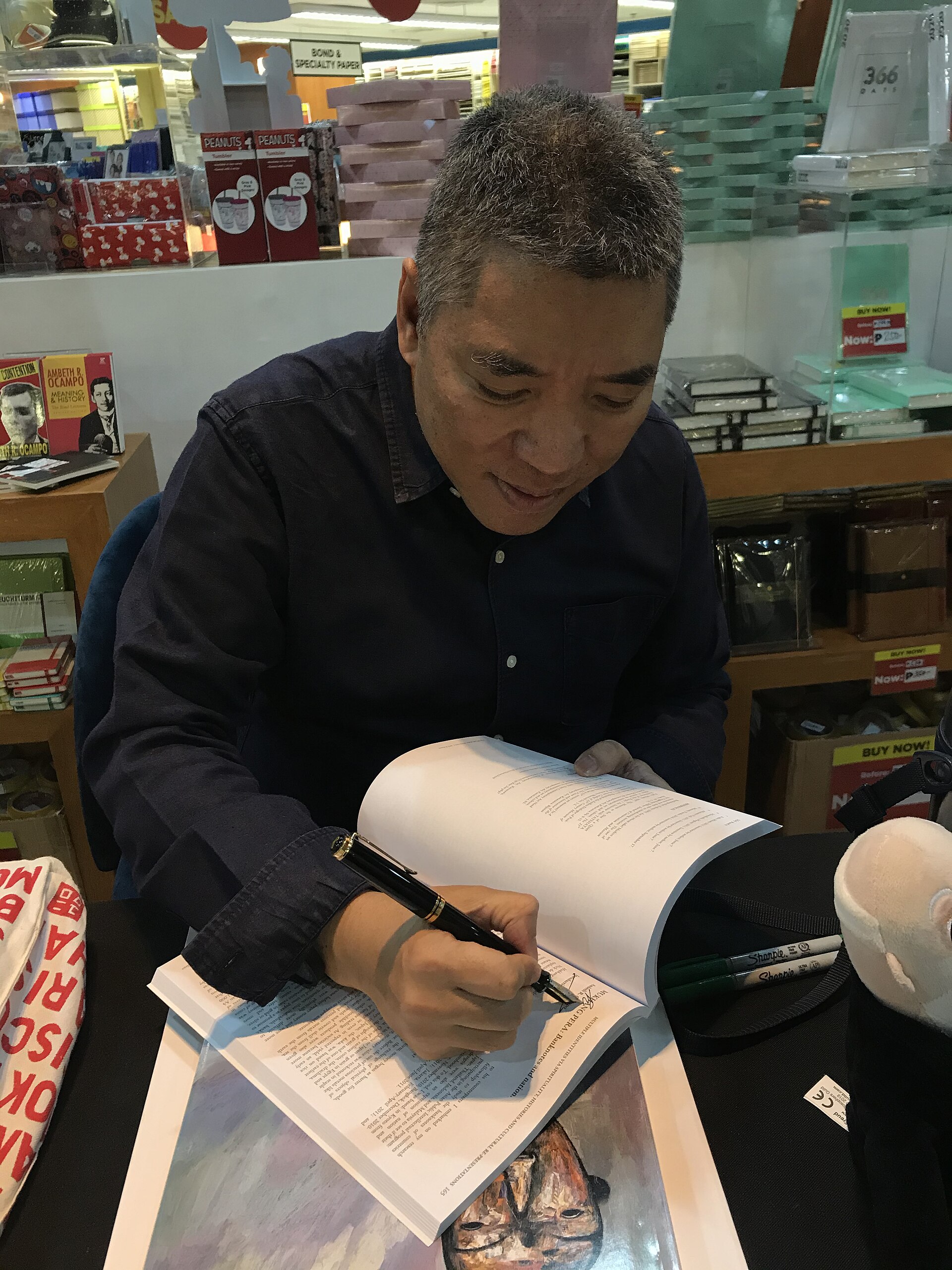 Author signing copies during a bookstore book launch