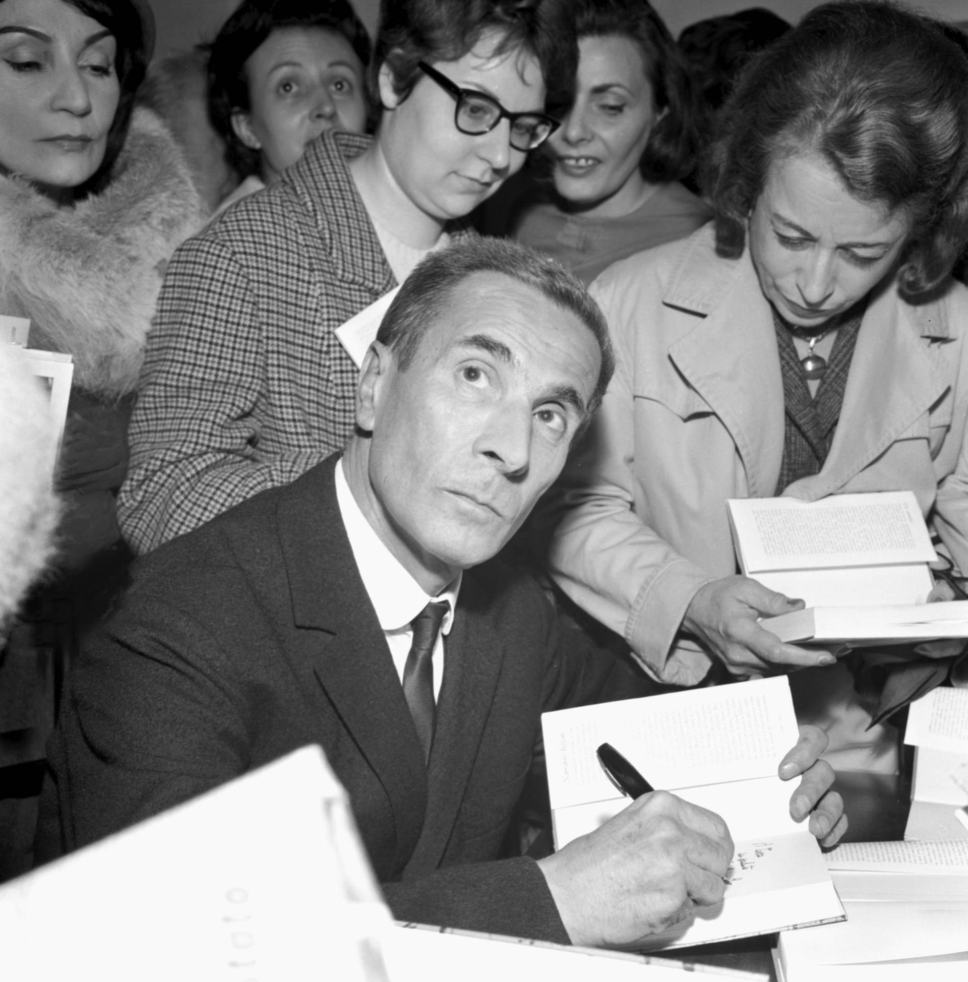Writer signing books in a bookstore setting