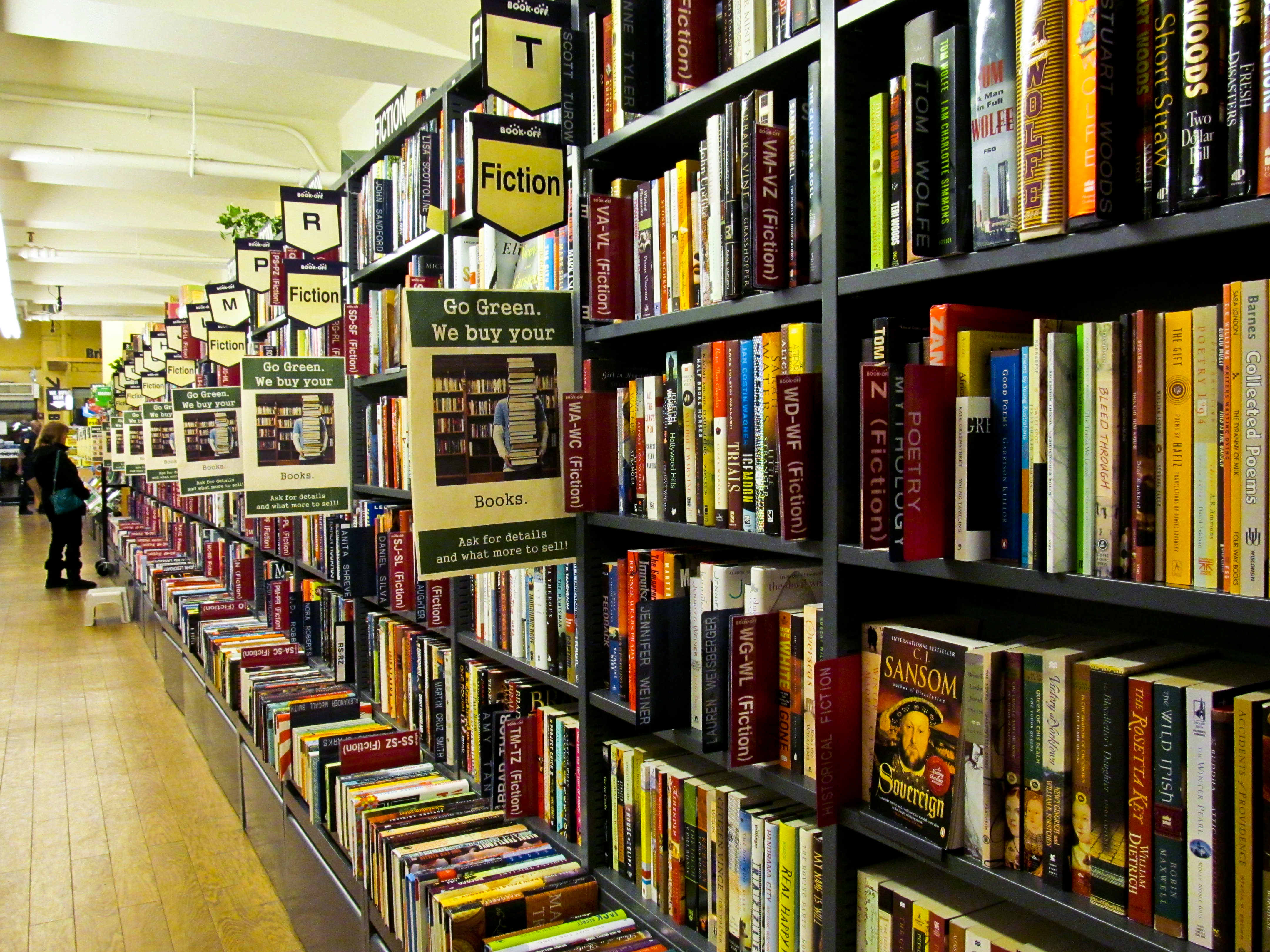 Reader-facing bookstore shelves with warm cinematic lighting