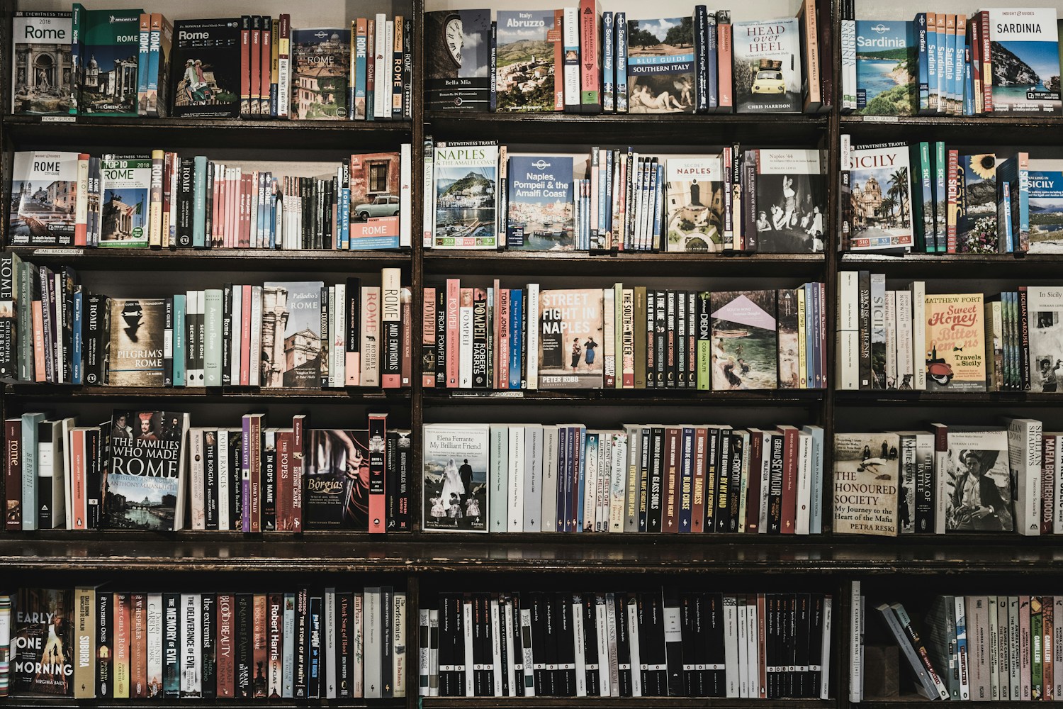 Bookstore shelves with colorful books and warm light
